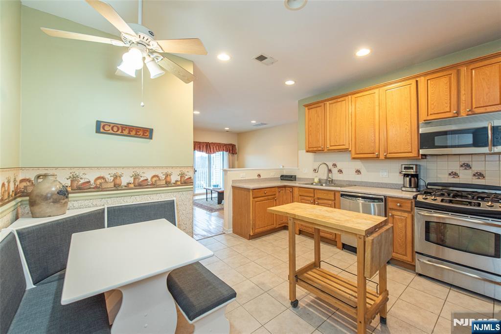 10323 Warrens Way Wanaque, NJ 07465 - Photo 11 of 30 a kitchen with a sink cabinets and window