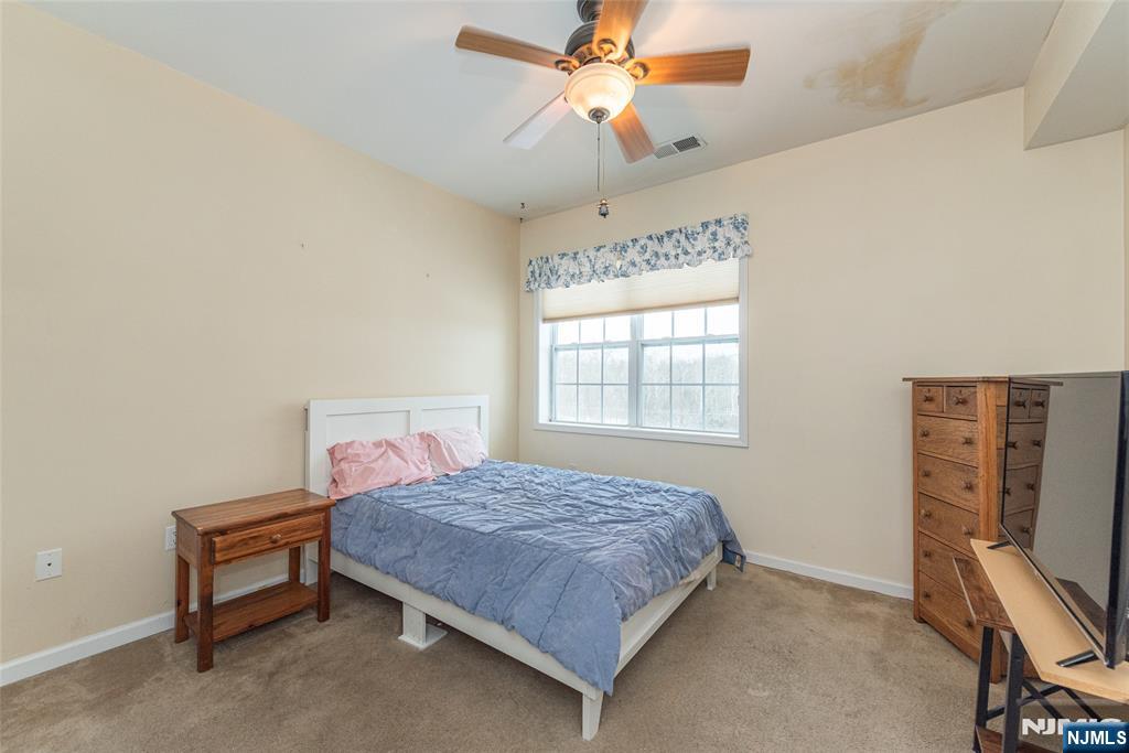 10323 Warrens Way Wanaque, NJ 07465 - Photo 17 of 30 a bedroom with a bed and a desk