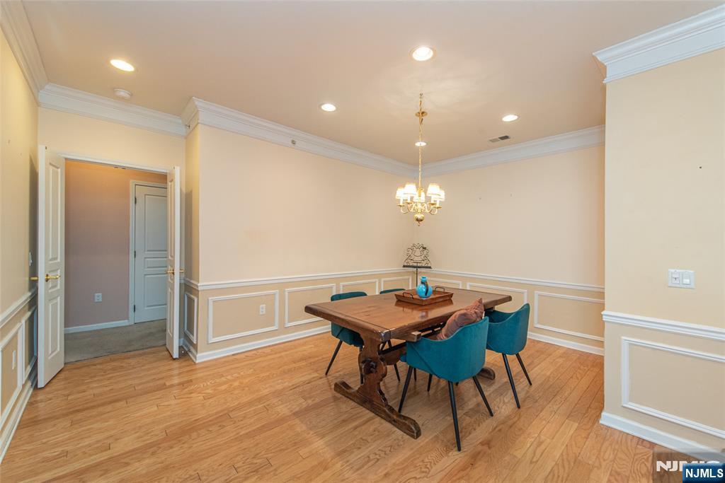 10323 Warrens Way Wanaque, NJ 07465 - Photo 6 of 30 a view of a dining room with furniture and wooden floor
