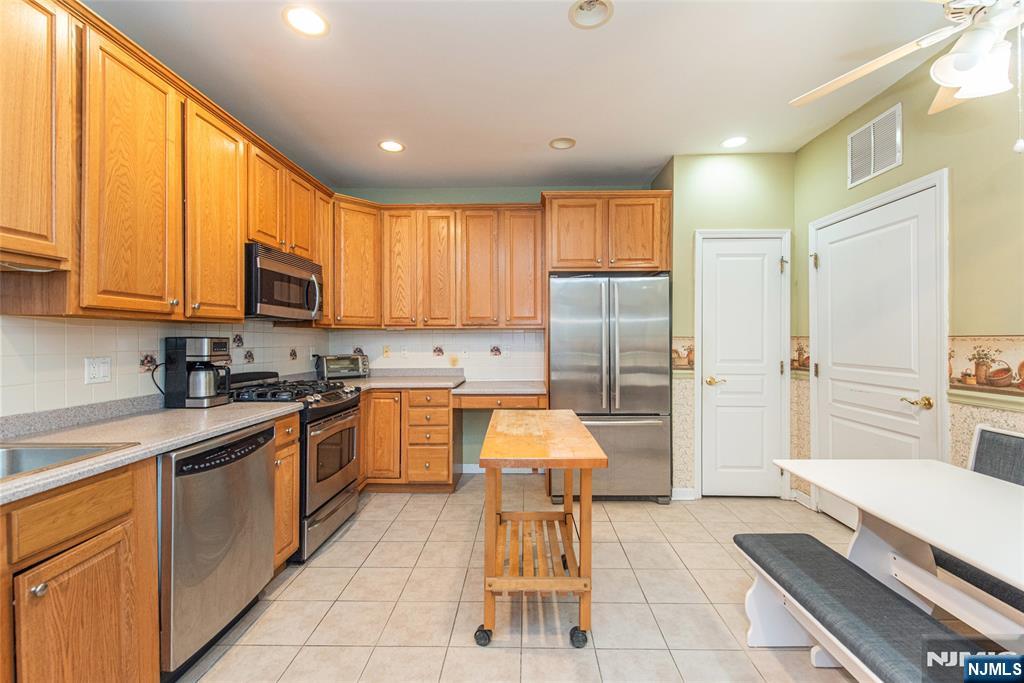 10323 Warrens Way Wanaque, NJ 07465 - Photo 9 of 30 a large kitchen with a large window and stainless steel appliances