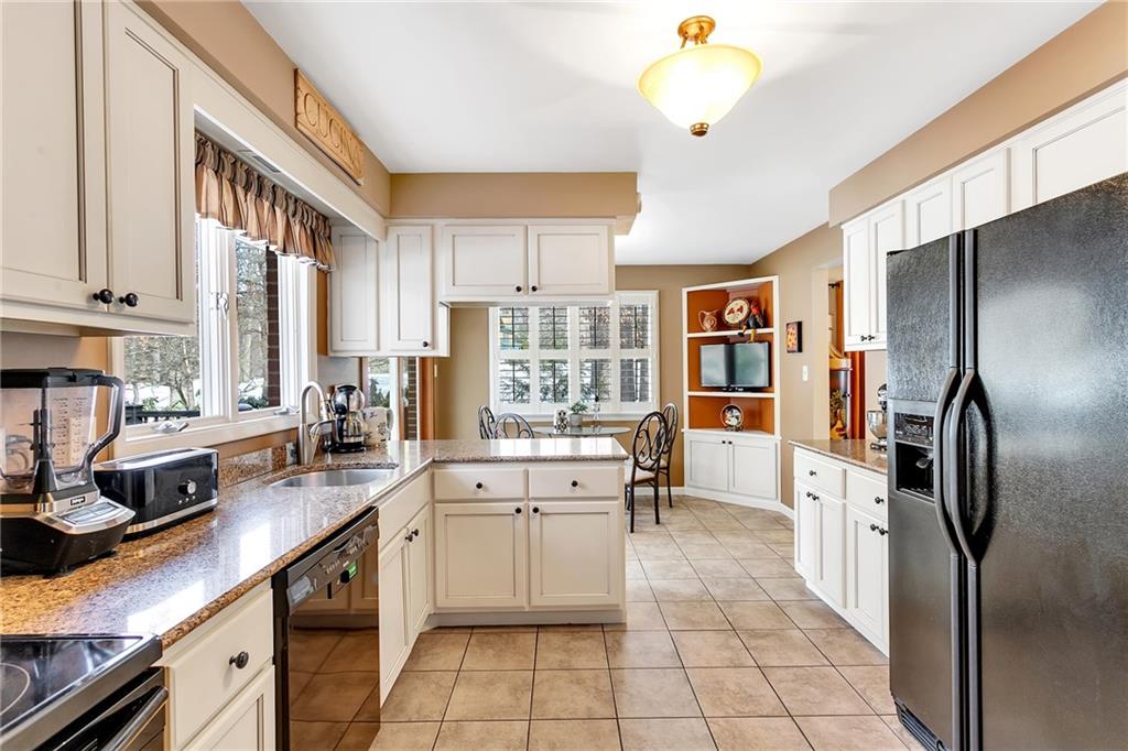 404 Golden Grove Road Baden, PA 15005 - Photo 14 of 25 a kitchen with stainless steel appliances a refrigerator sink and cabinets
