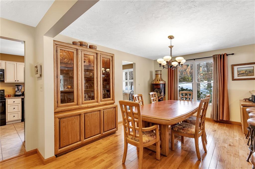 404 Golden Grove Road Baden, PA 15005 - Photo 9 of 25 a dining room with furniture wooden floor a rug and a chandelier