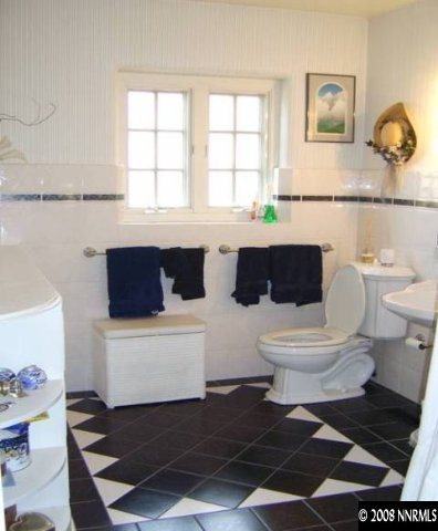 665 Manor Drive Reno, NV 89509 - Photo 5 of 9 a bathroom with a toilet a sink and a window
