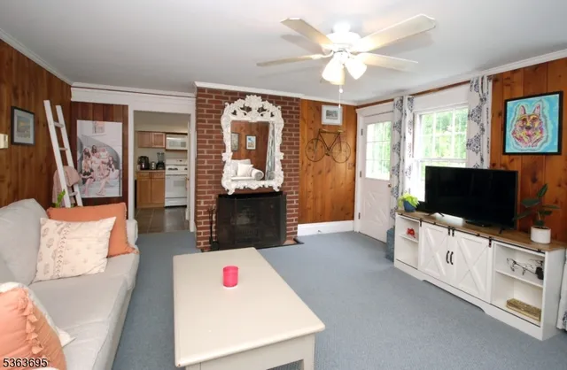 a living room with furniture and a chandelier
