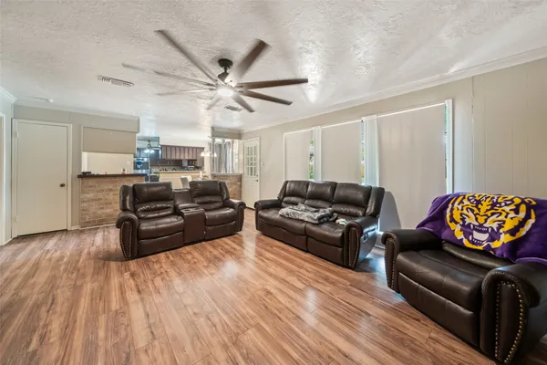 a living room with furniture and wooden floor