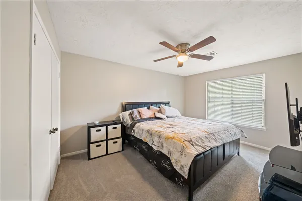 a bed sitting in a bedroom next to a window