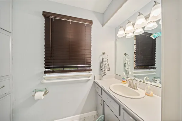 a bathroom with a sink vanity and a mirror