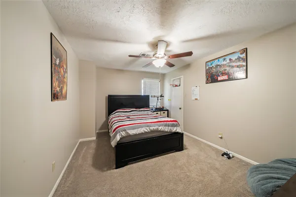 a bedroom with bed and a chandelier