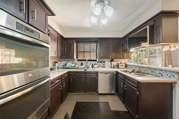 a kitchen with stainless steel appliances granite countertop a sink and stove