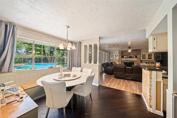 a view of a dining room with furniture window and wooden floor