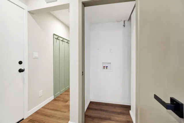 a view of a hallway with wooden floor