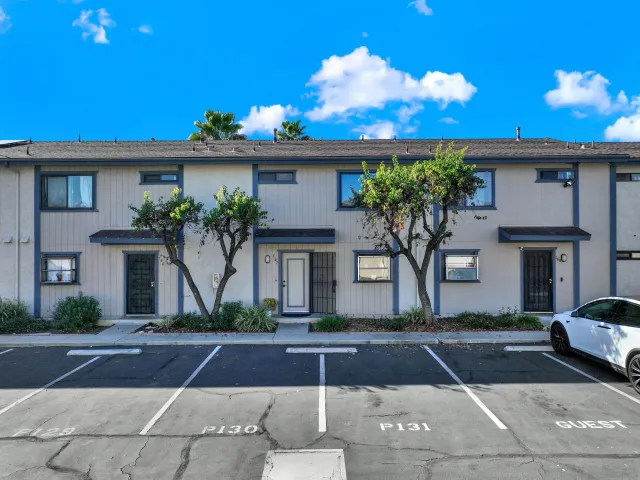 a front view of a house with a yard and a garage
