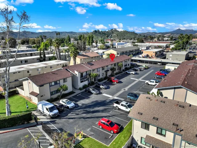 a view of a patio with table and chairs with wooden floor and fence