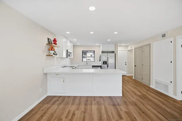 a view of kitchen with furniture and refrigerator