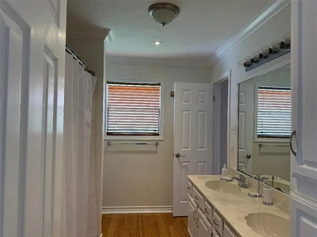 a bathroom with a granite countertop sink a mirror and a shower