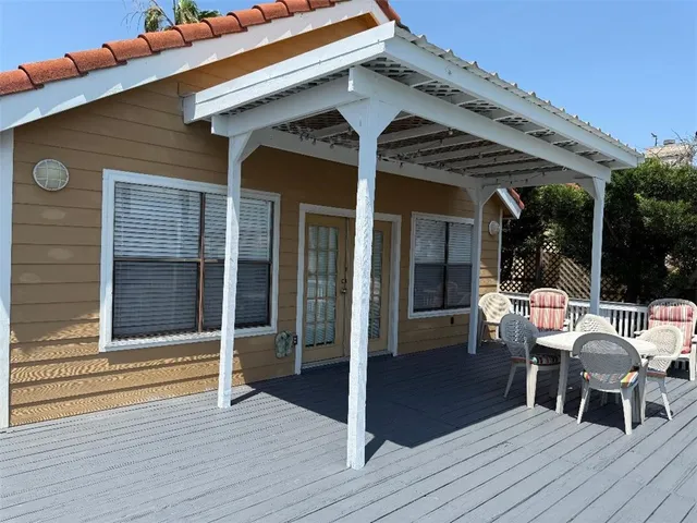 a view of a patio with table and chairs