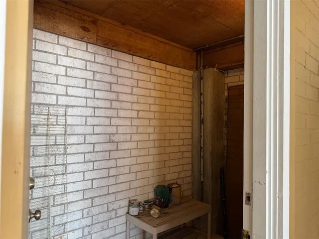 a view of a roof deck with table and chairs a barbeque with wooden floor and fence