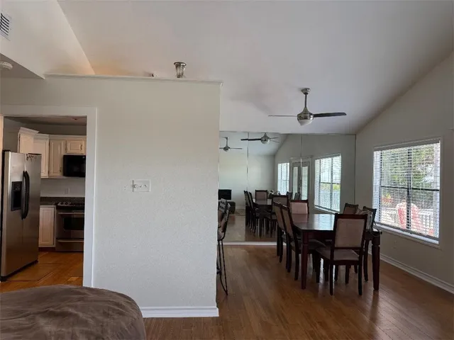 a view of a a dining room with furniture window and wooden floor
