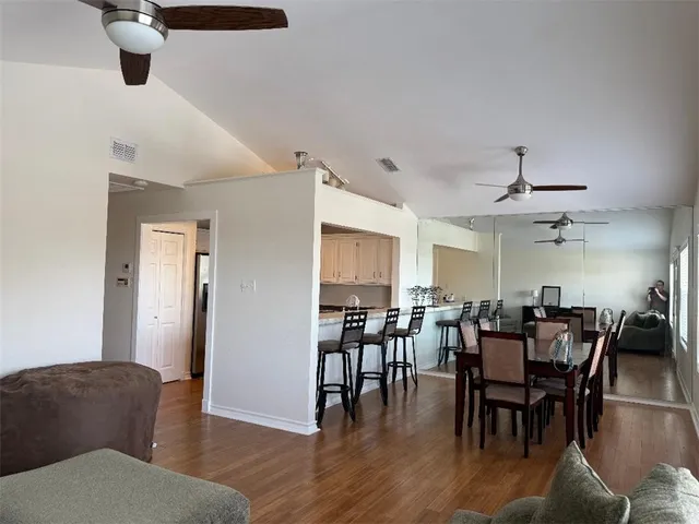 a view of a dining room with furniture and wooden floor
