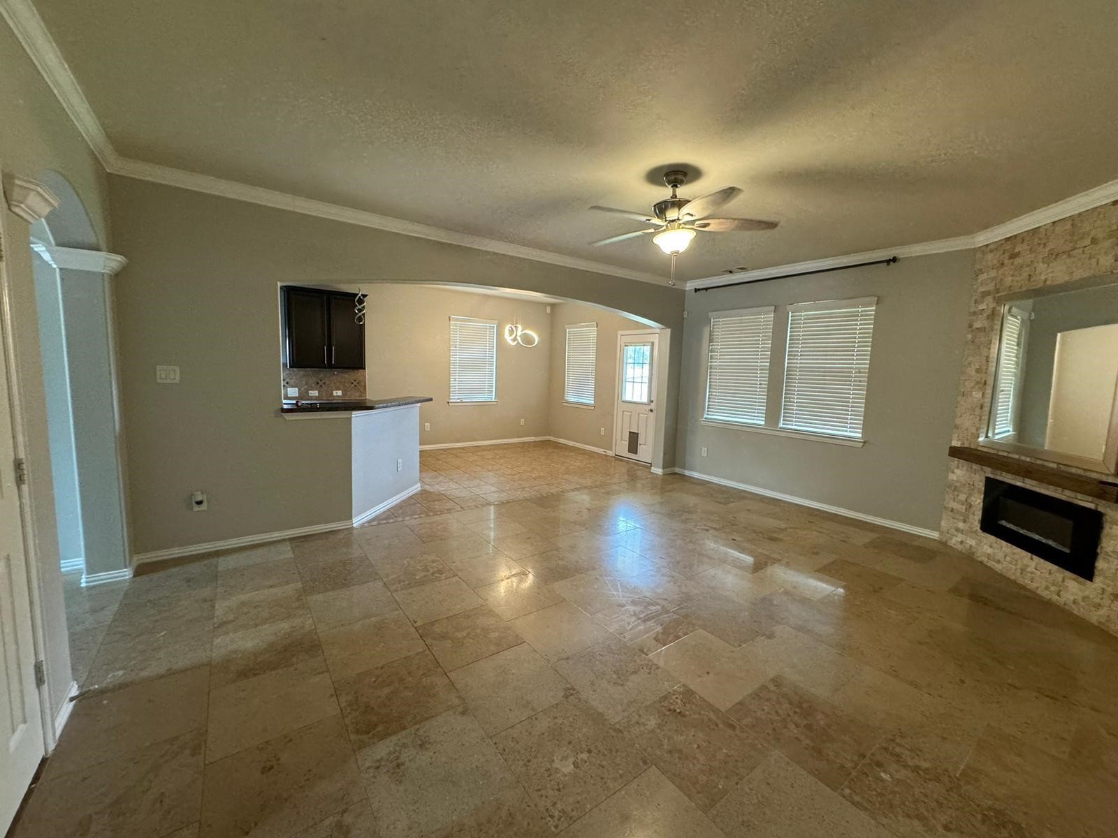 25614 Crisp Spring Lane Spring, TX 77373 - Photo 3 of 25 a view of a livingroom with a flat screen tv ceiling fan and window