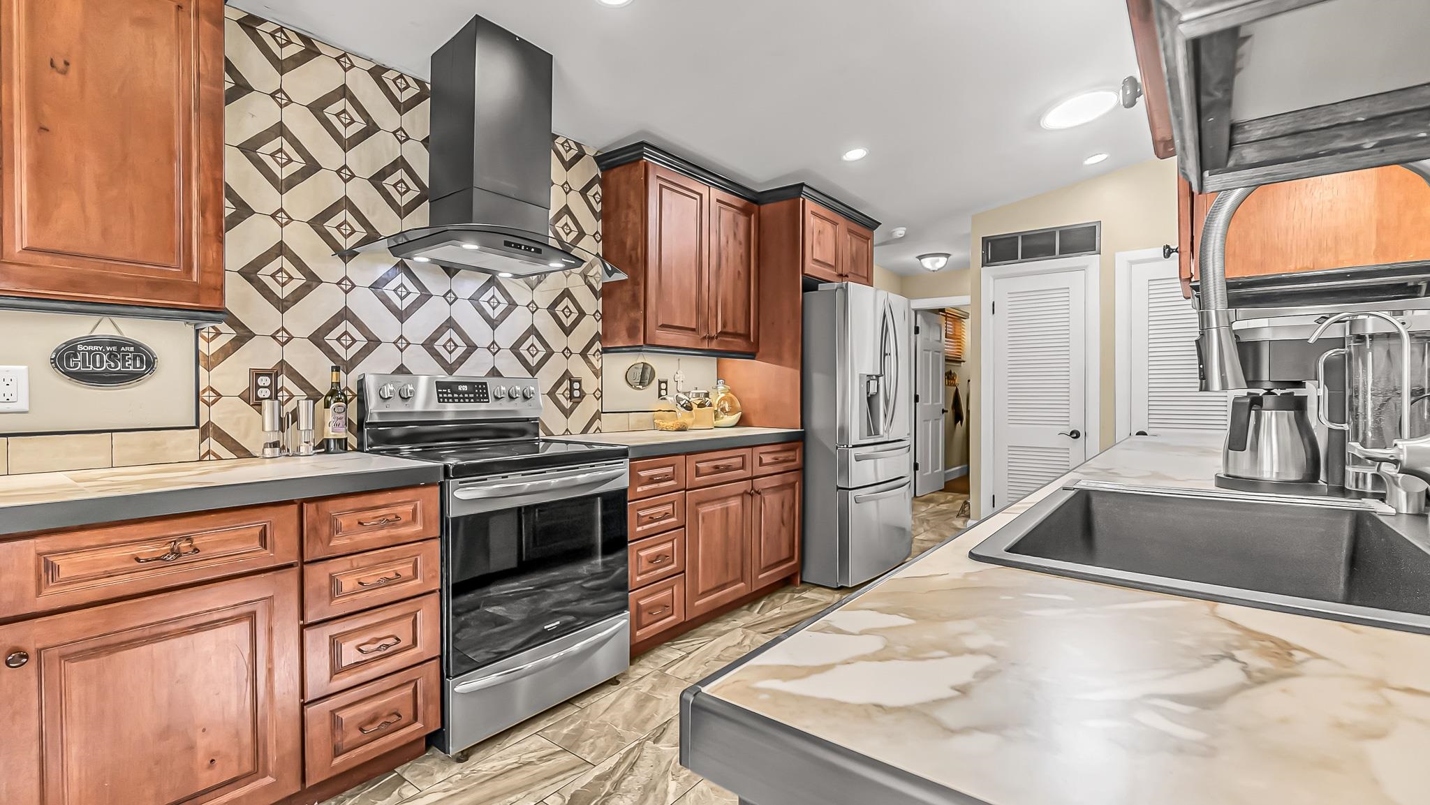 623 26 Road Grand Junction, CO 81505 - Photo 12 of 42 a kitchen with stainless steel appliances granite countertop a sink stove and refrigerator