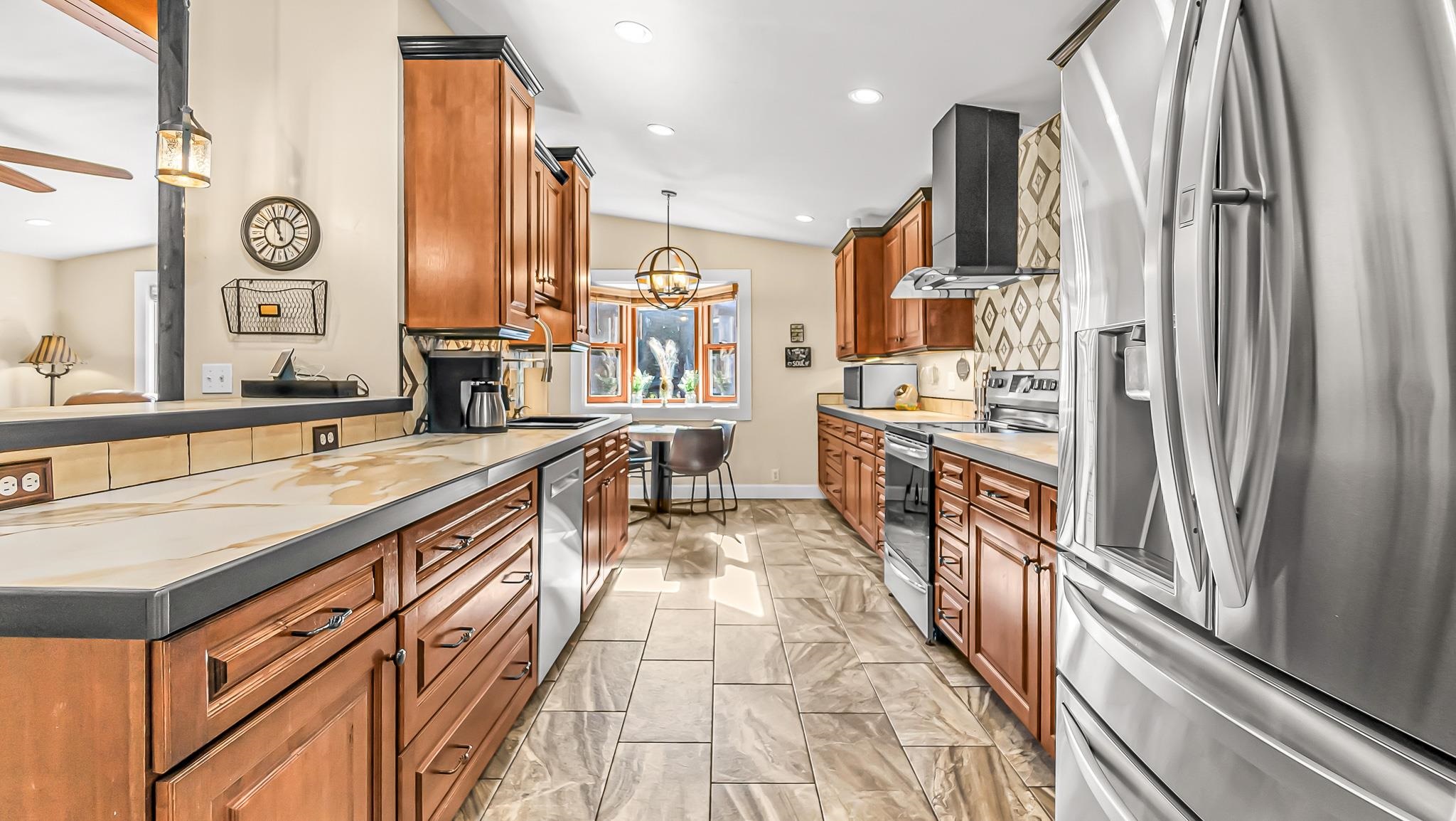 623 26 Road Grand Junction, CO 81505 - Photo 13 of 42 a large kitchen with stainless steel appliances a large counter top a stove a chimney a sink and a refrigerator