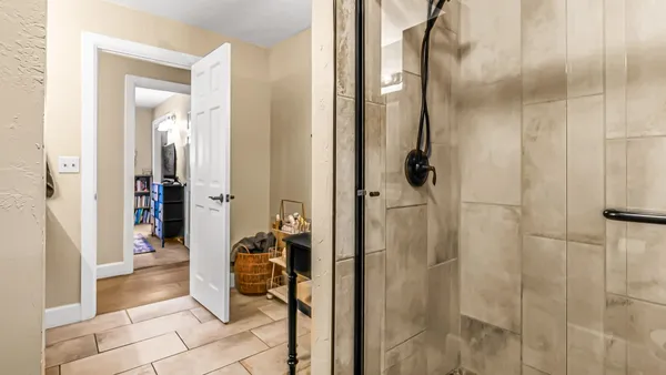 a bathroom with a sink a toilet a mirror and shower