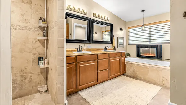 a living room with furniture a flat screen tv and a floor to ceiling window