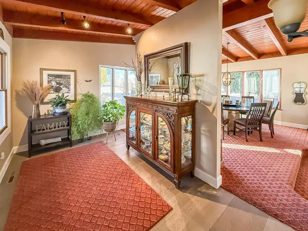 a large kitchen with stainless steel appliances a large counter top a stove a chimney a sink and a refrigerator