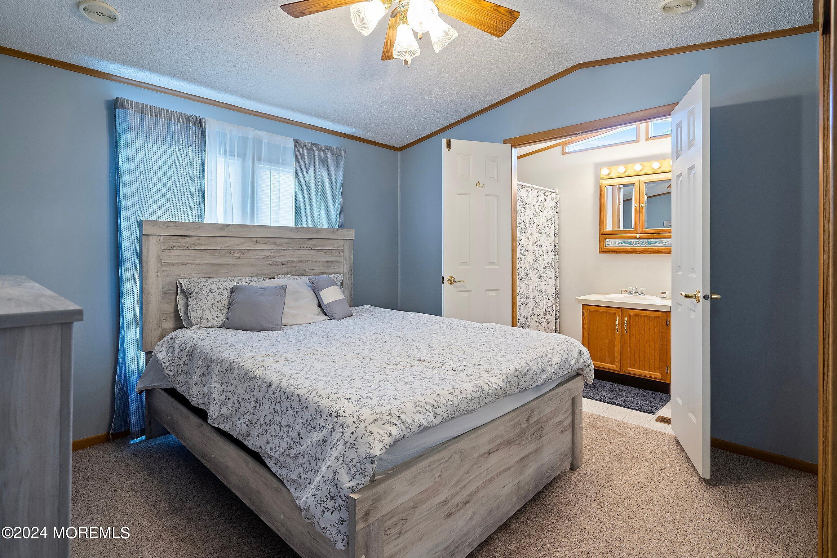 11 Ruffian Way Howell, NJ 07731 - Photo 11 of 17 a bedroom with a bed and a chandelier