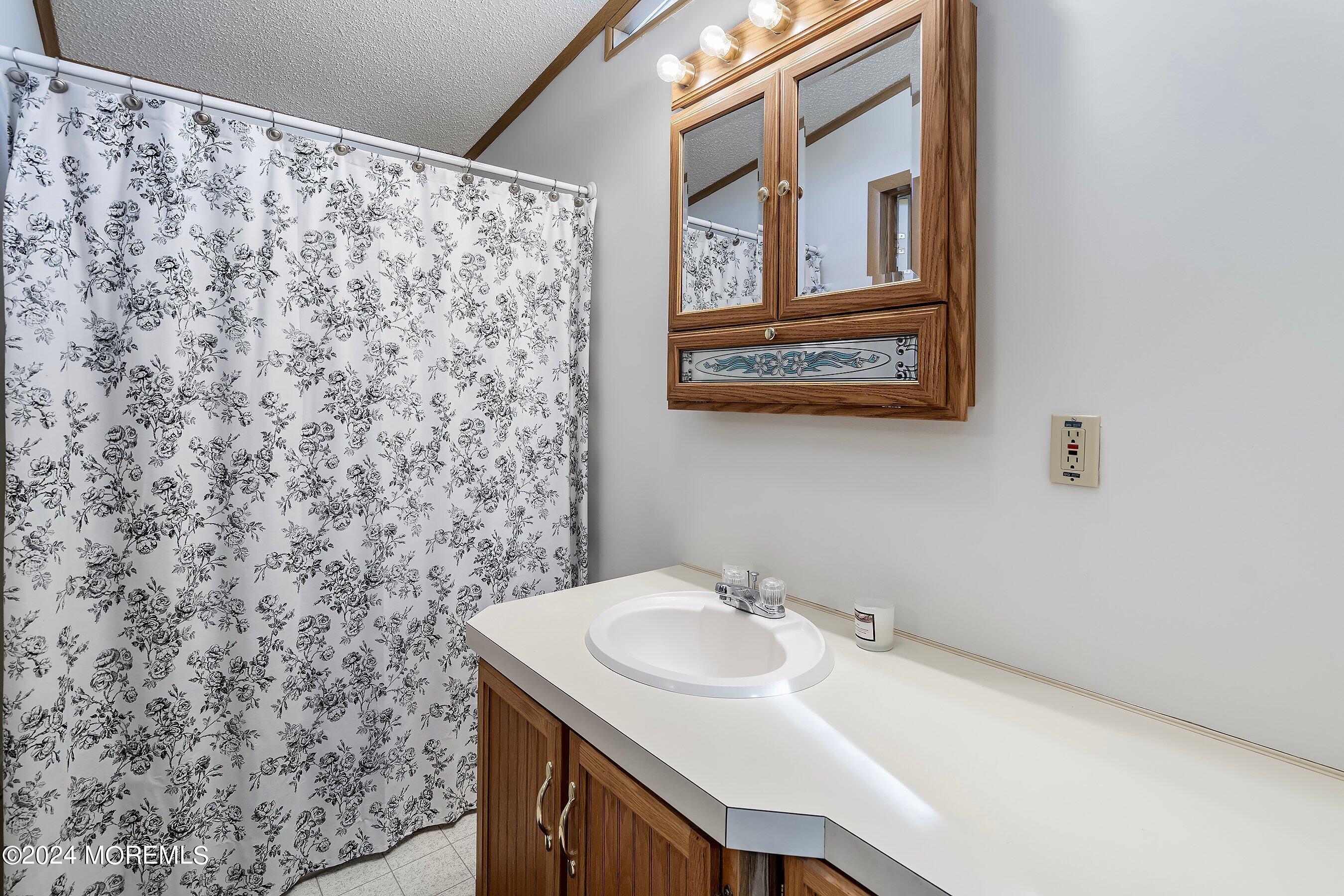11 Ruffian Way Howell, NJ 07731 - Photo 12 of 17 a bathroom with a sink and a mirror