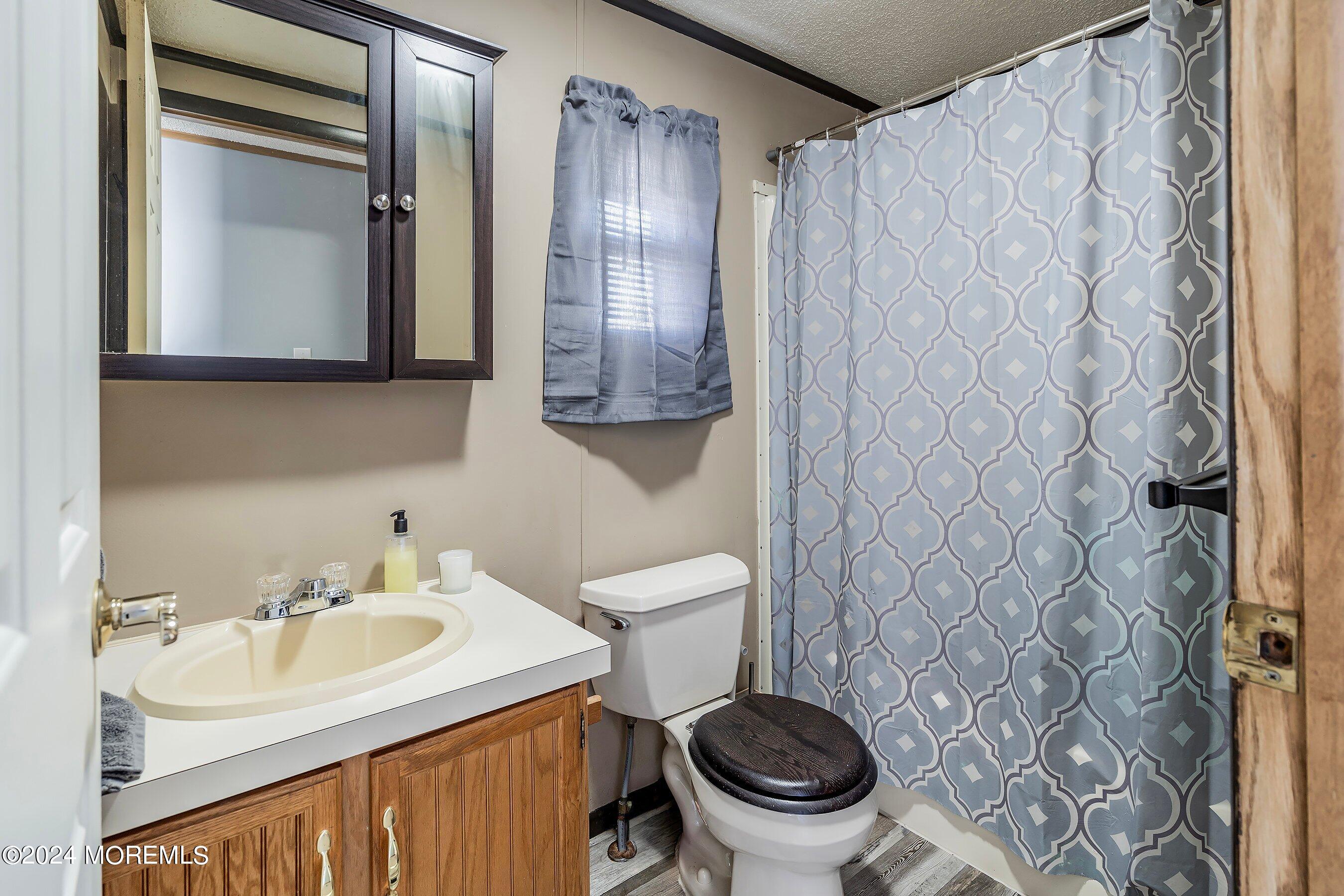 11 Ruffian Way Howell, NJ 07731 - Photo 14 of 17 a bathroom with a sink toilet and mirror