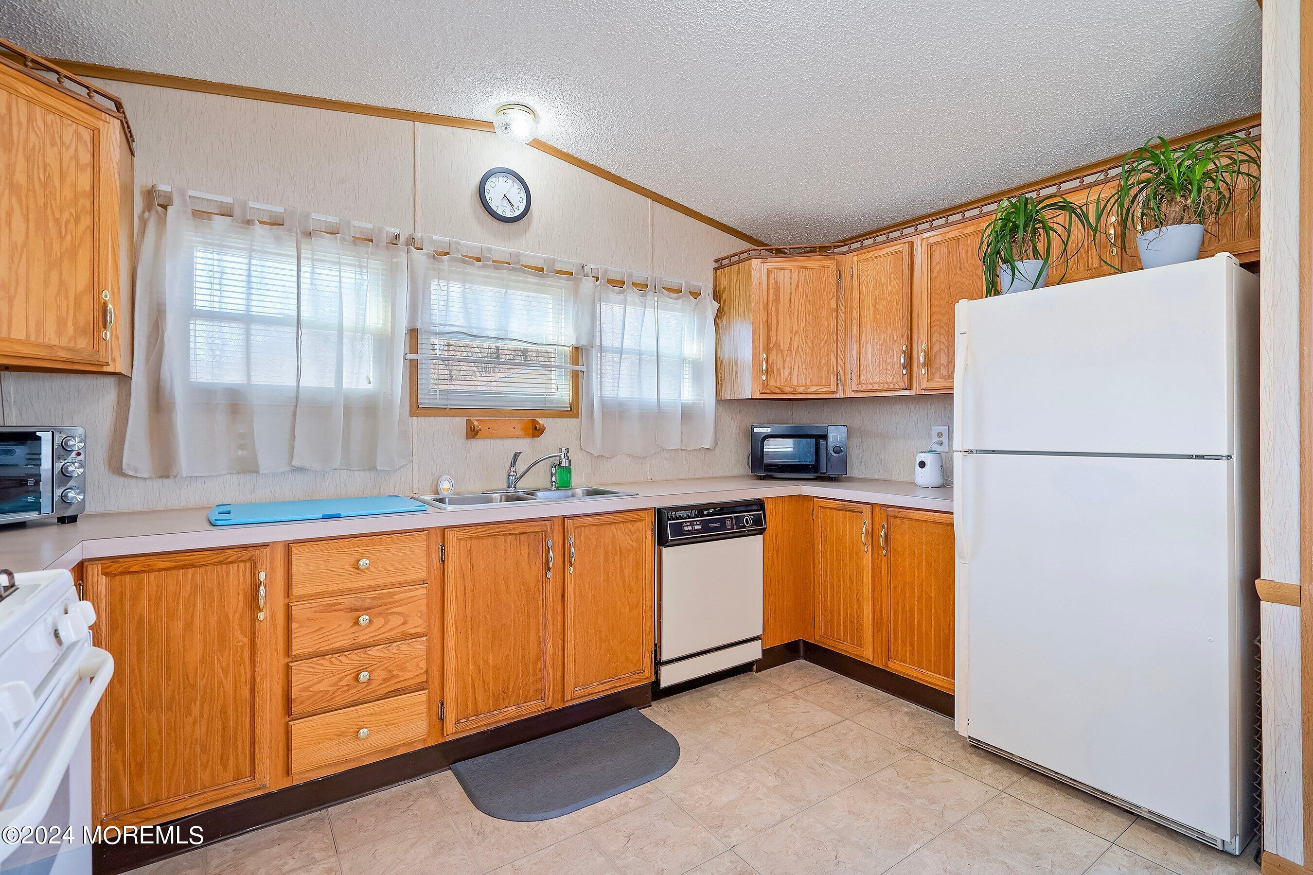 11 Ruffian Way Howell, NJ 07731 - Photo 8 of 17 a kitchen with stainless steel appliances granite countertop a refrigerator and a sink