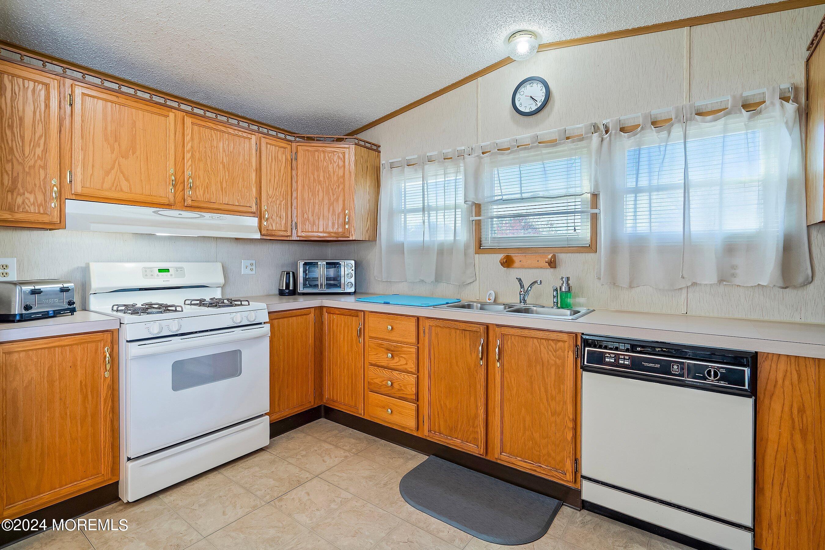 11 Ruffian Way Howell, NJ 07731 - Photo 9 of 17 a kitchen with stainless steel appliances granite countertop a sink a stove cabinets counter space and a window