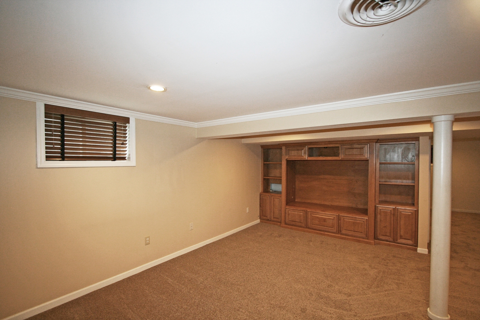 1125 Woodview Road Burr Ridge, IL 60527 - Photo 16 of 22 a view of an empty room with exposed radiator and window