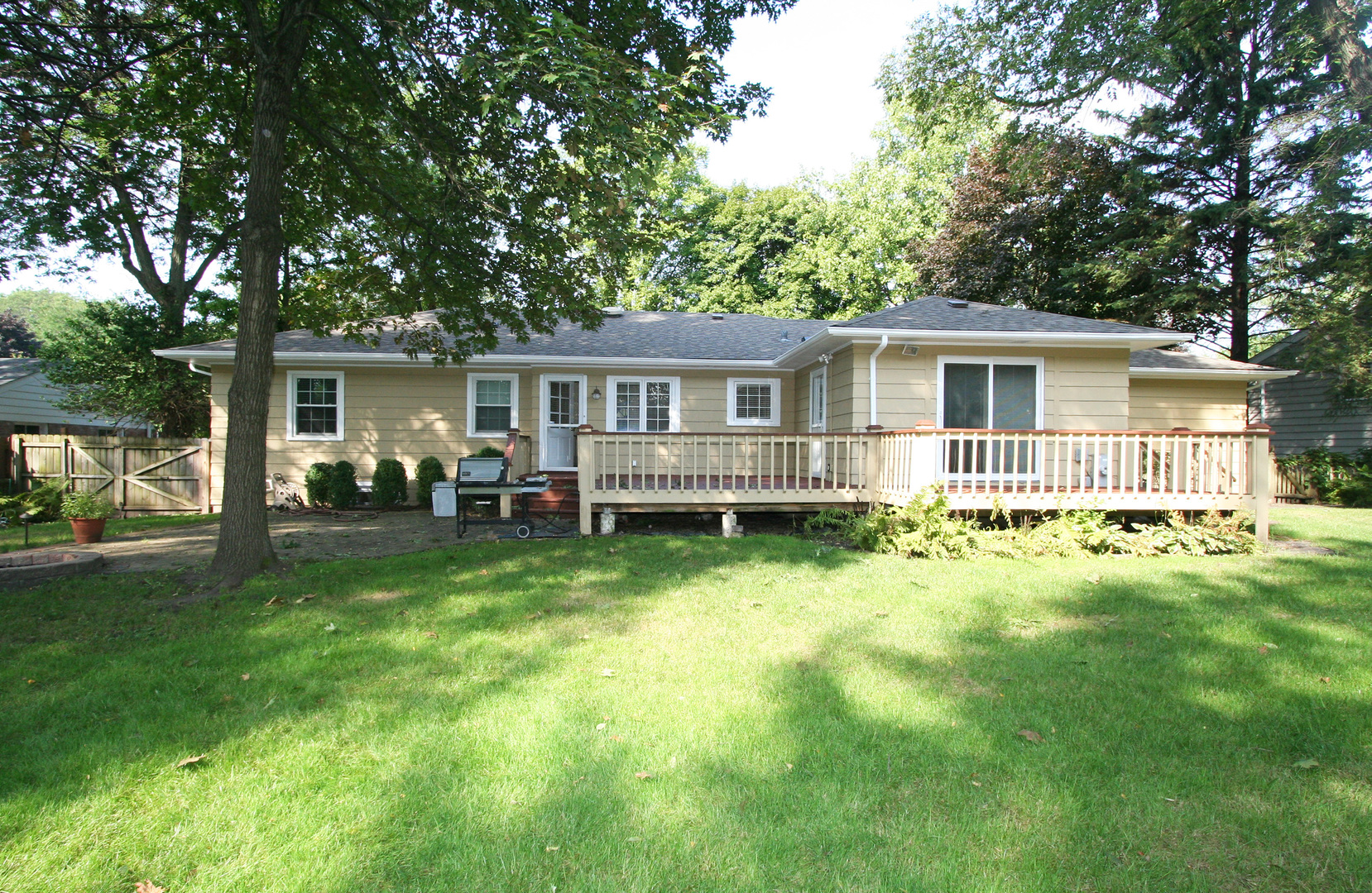 1125 Woodview Road Burr Ridge, IL 60527 - Photo 20 of 22 a view of a house with a backyard and a patio