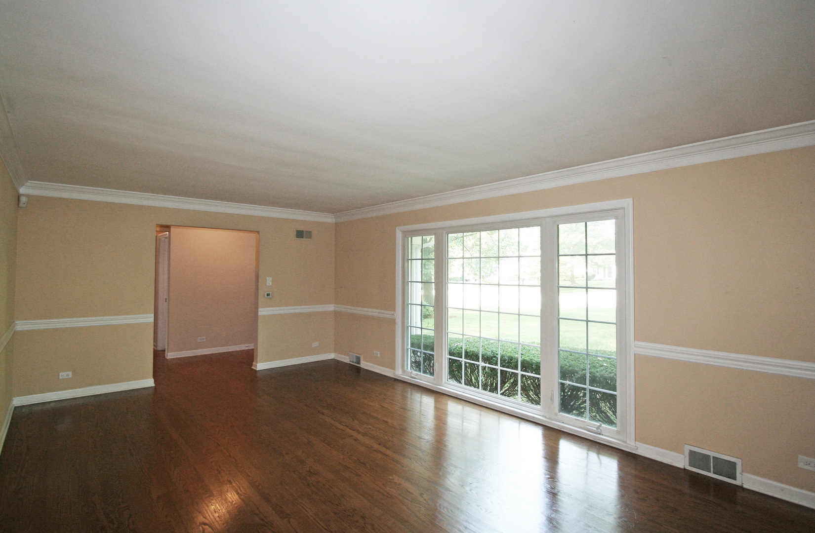 1125 Woodview Road Burr Ridge, IL 60527 - Photo 3 of 22 wooden floor in an empty room with a window
