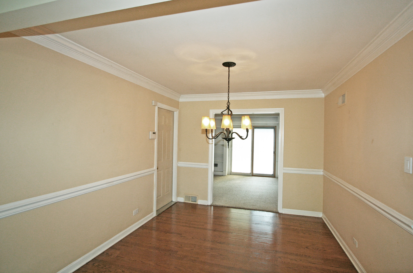 1125 Woodview Road Burr Ridge, IL 60527 - Photo 4 of 22 a view of empty room with window and wooden floor