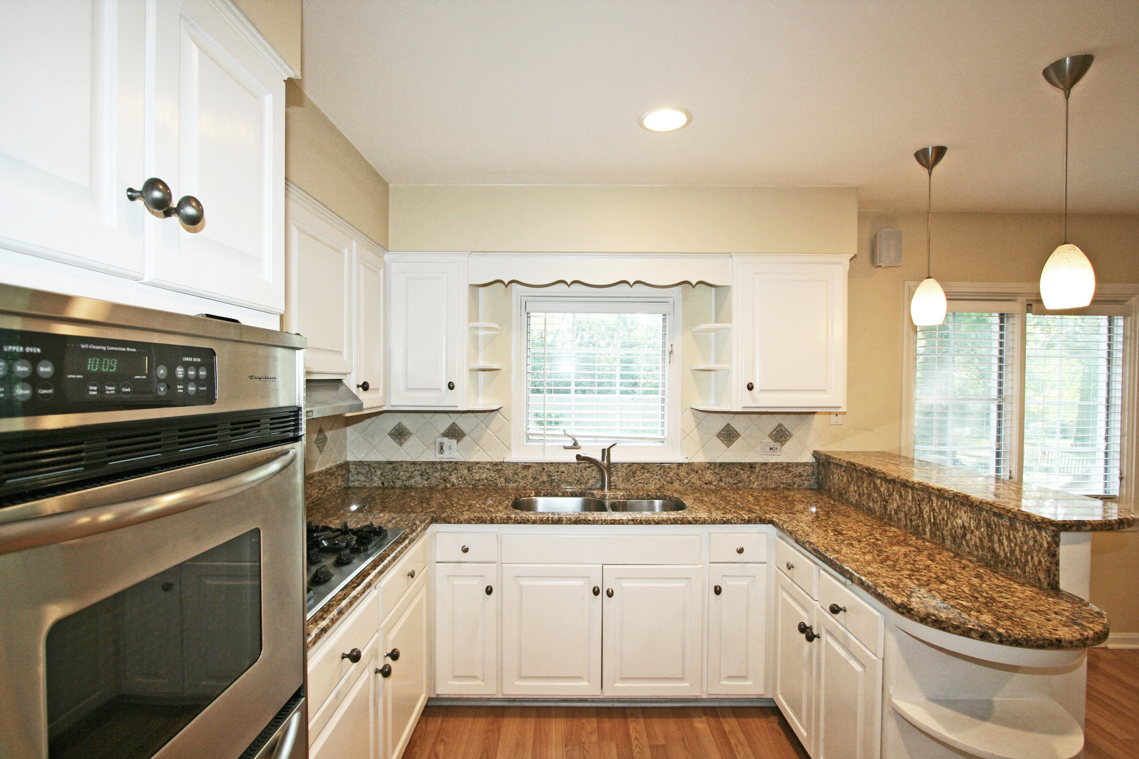 1125 Woodview Road Burr Ridge, IL 60527 - Photo 7 of 22 a kitchen with granite countertop a stove a sink and a granite counter tops