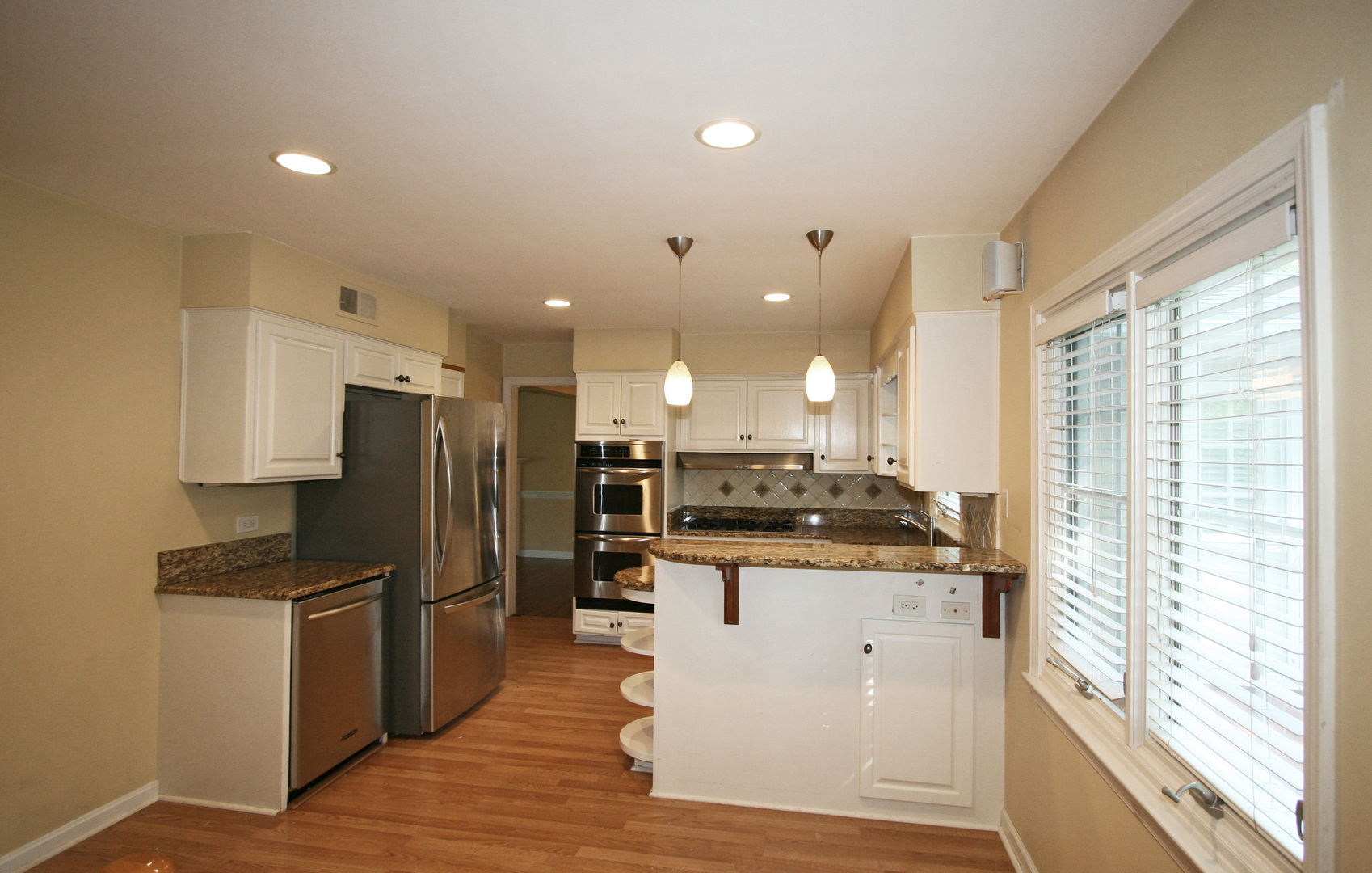 1125 Woodview Road Burr Ridge, IL 60527 - Photo 8 of 22 a kitchen with stainless steel appliances kitchen island granite countertop a stove a refrigerator a sink and a refrigerator