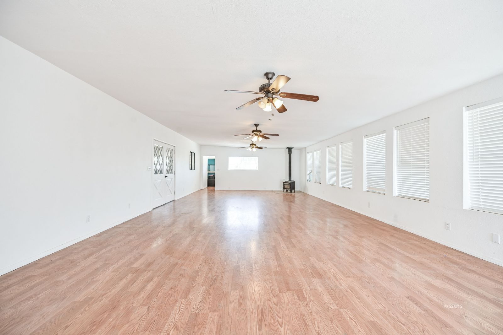 1407 North Indian Wells Street Ridgecrest, CA 93555 - Photo 24 of 50 a view of empty room with wooden floor and fan