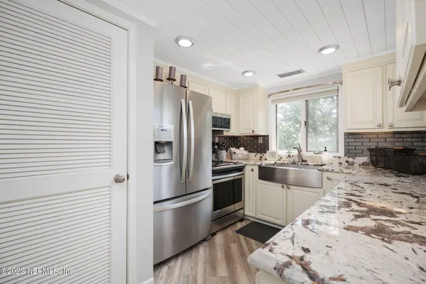 a kitchen with a refrigerator stove and sink