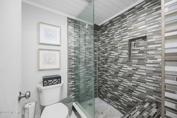 a bathroom with a toilet and a shower