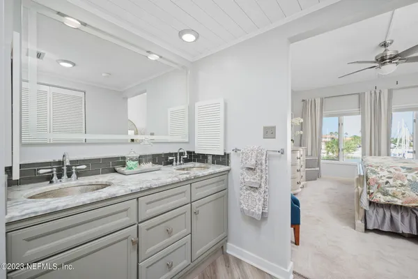 a spacious bathroom with double sink and a mirror