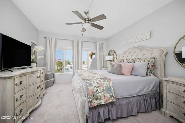 a bedroom with a large bed and a flat screen tv