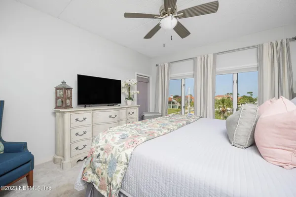 a bedroom with a large bed and a flat screen tv