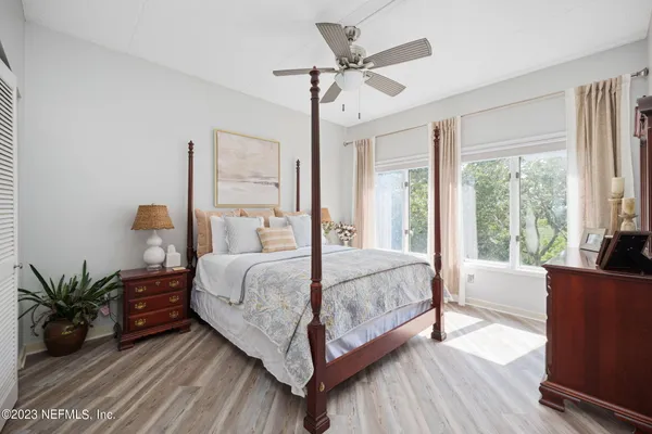 a bedroom with a large bed and a large window