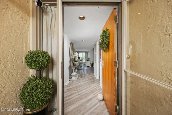 a view of entryway and hall with wooden floor