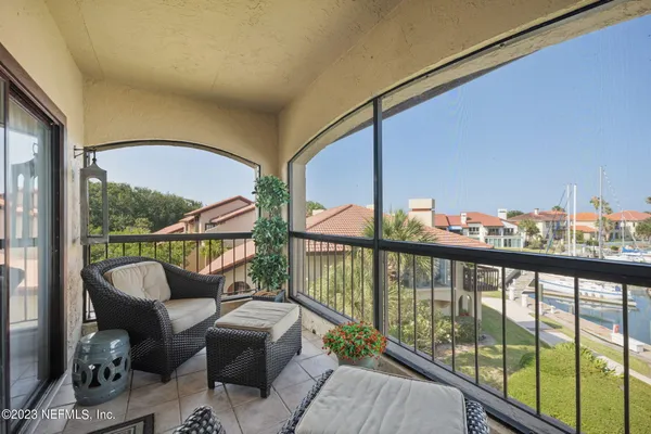 a balcony with furniture and a potted plant