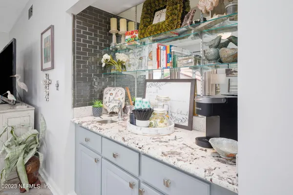 a kitchen with granite countertop lots of clutter and stainless steel appliances